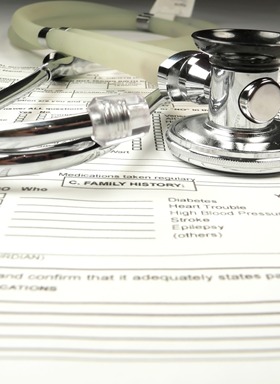 A stethoscope and some other medical equipment on top of a paper.